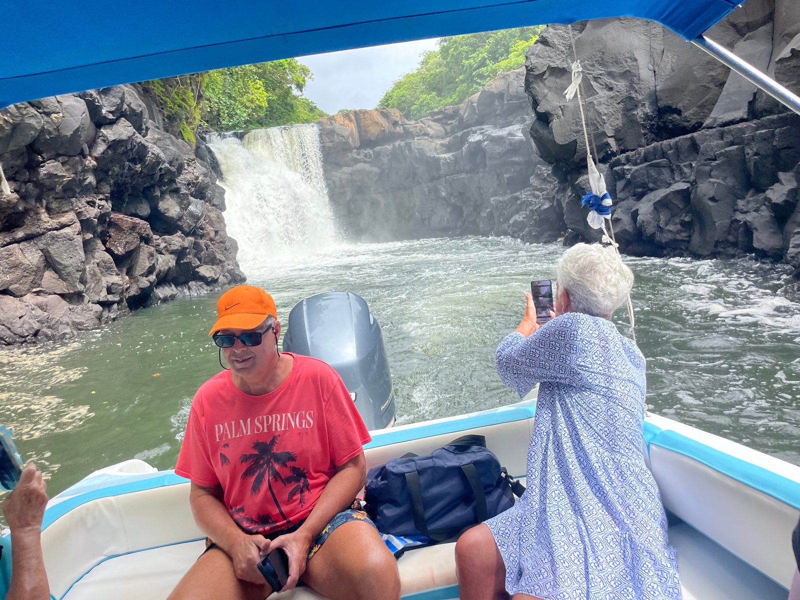 passengers-on-boat-beside-waterfall-04