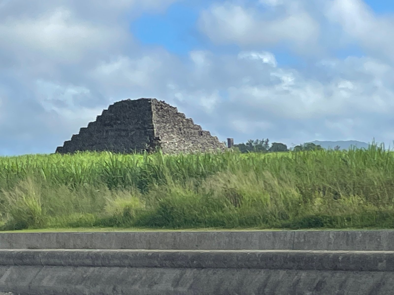 stone-pyramid-in-grassy-field-01
